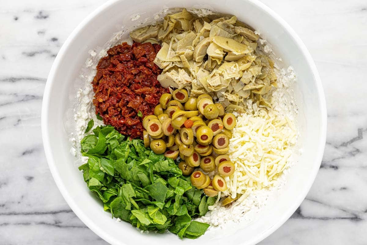 Bowl of veggies and cheese with creamy garlic bread filling.