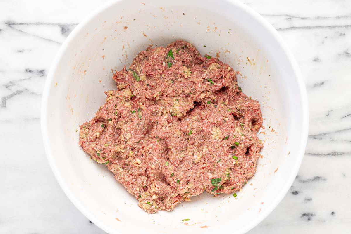 Large bowl filled with meatball mixture.