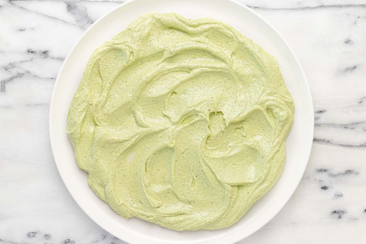 Creamy whipped feta spread across a serving platter.