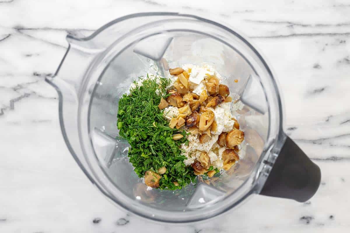 Vitamix blender filled with ingredients for whipped feta.