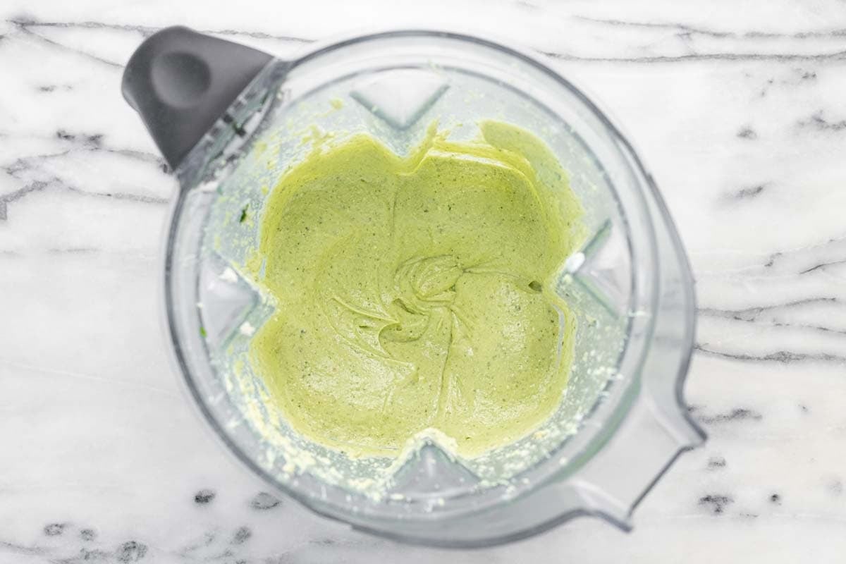 Vitamix blender filled with herby whipped feta cheese.