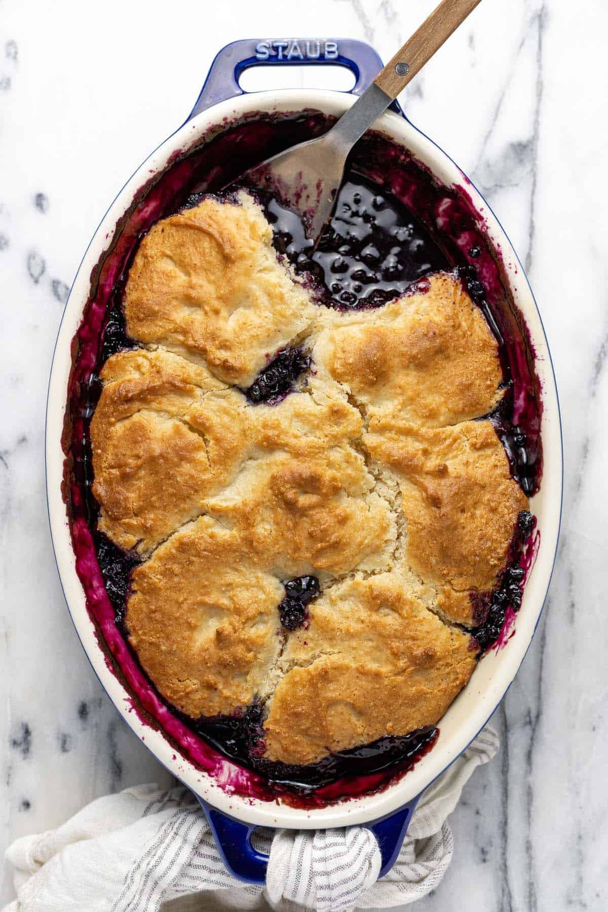 Large baking dish filled with homemade blueberry cobbler.