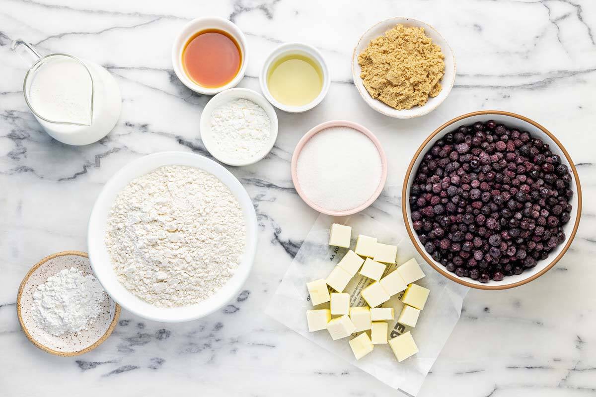 Bowls of ingredients to make homemade blueberry cobbler.