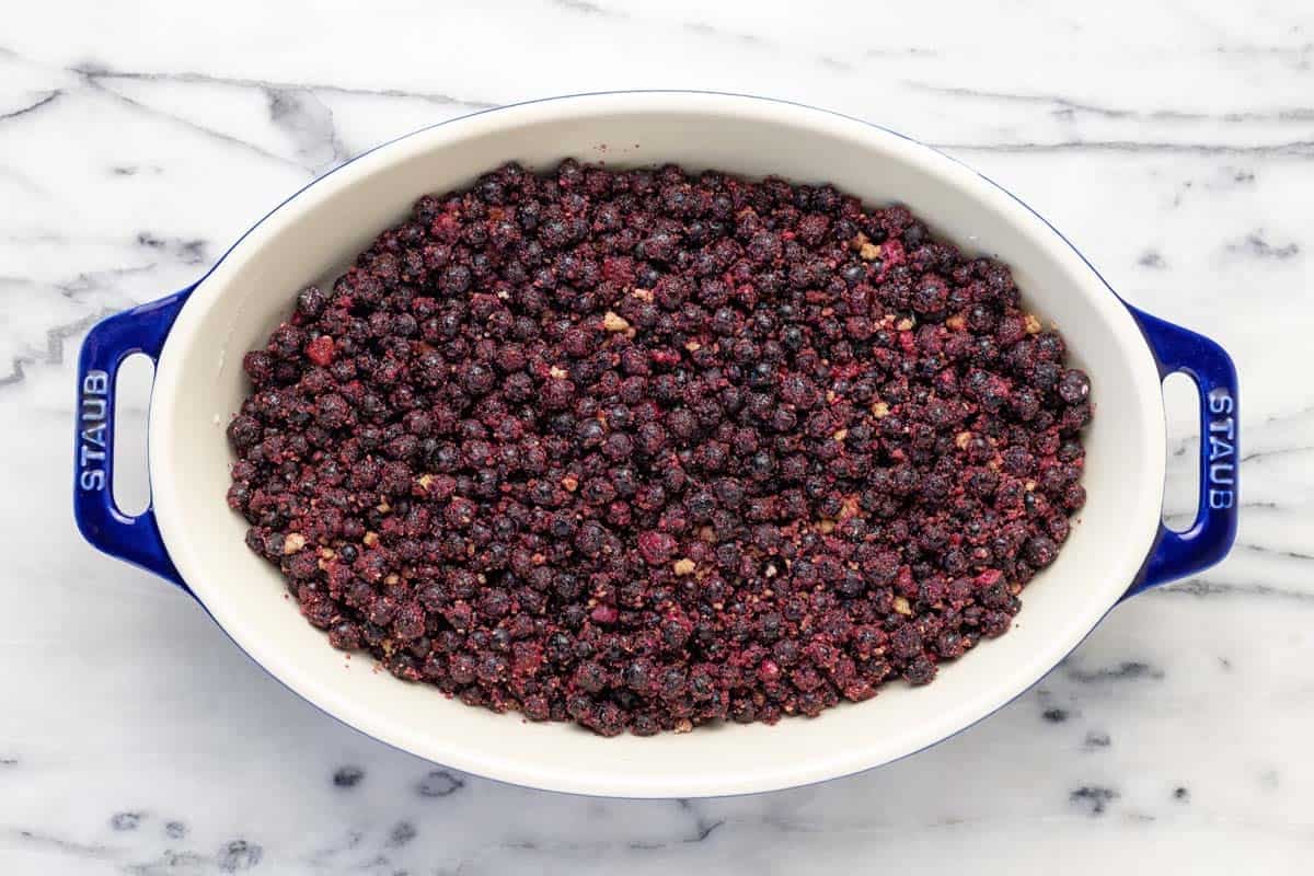 Blueberries, sugar, lemon juice, and cornstarch mixed together in a baking dish.