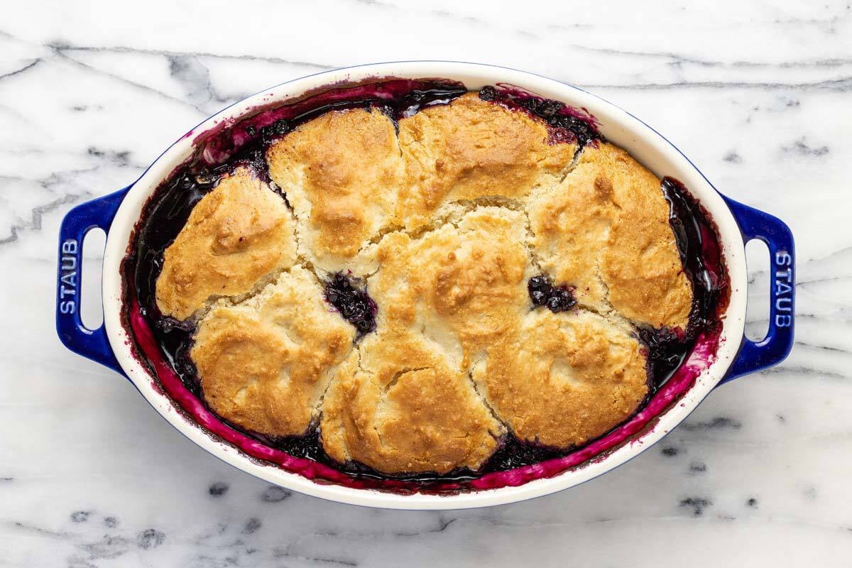 Freshly baked blueberry cobbler in a large baking dish.