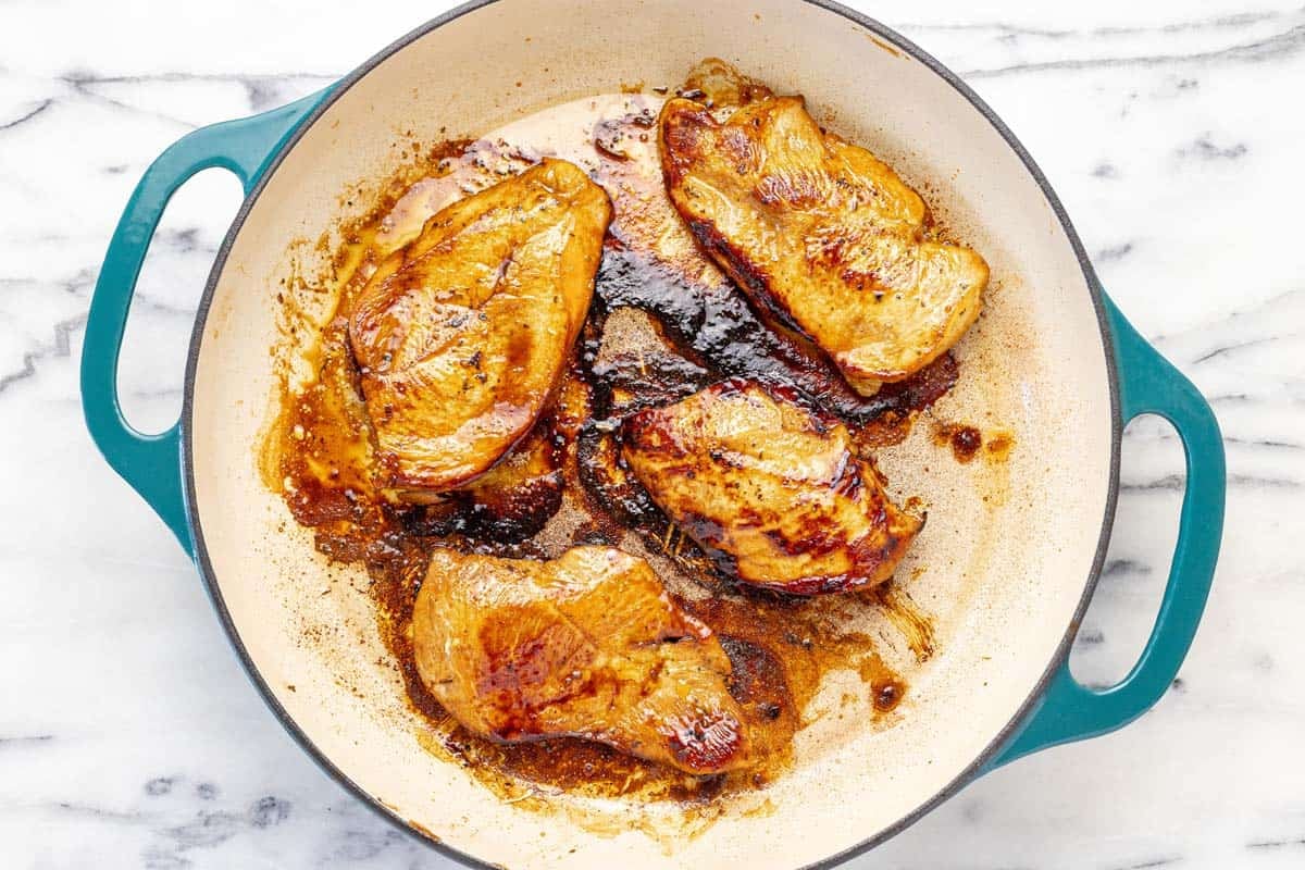 Cooked chicken breast in a large pan.
