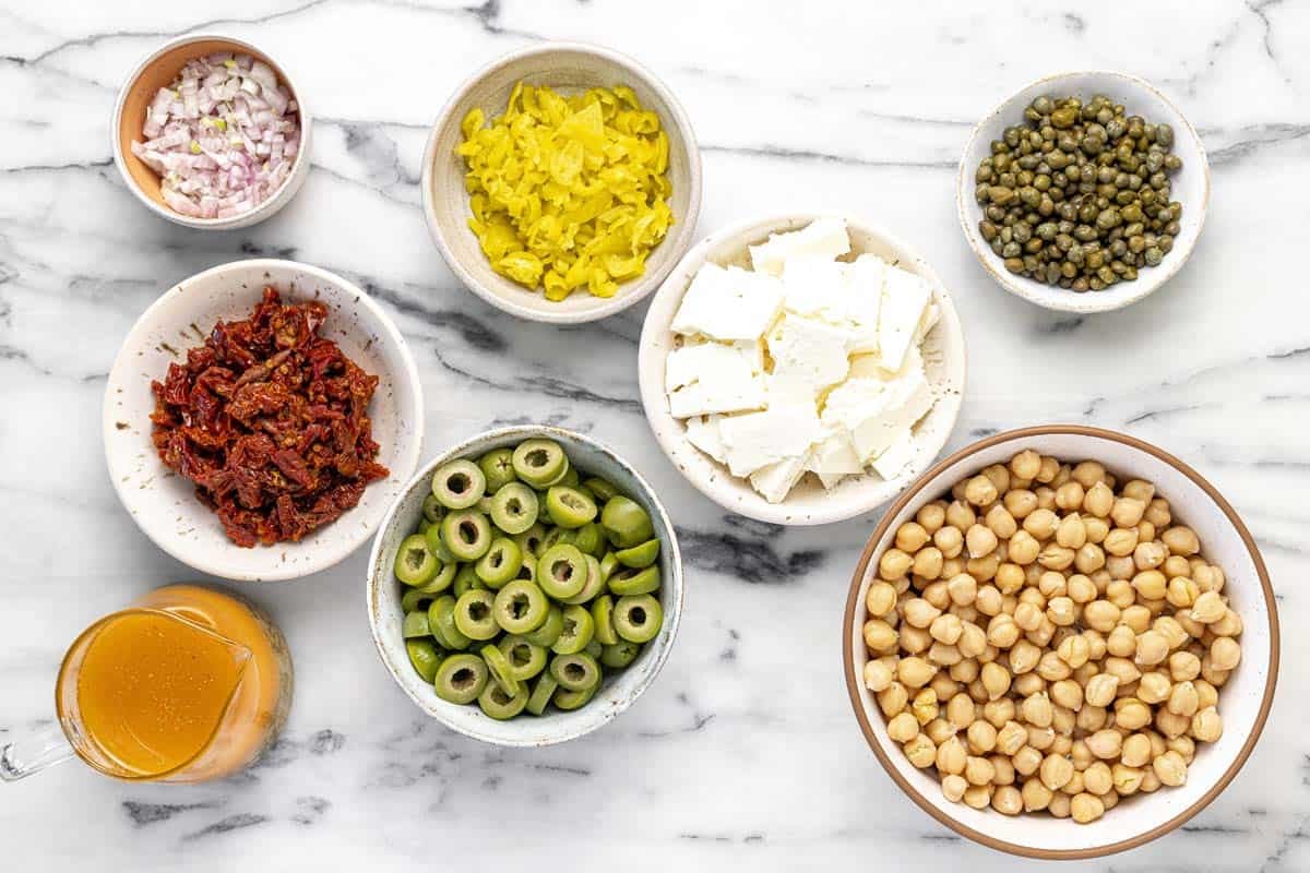 Bowls of ingredients to make marinated chickpea salad.