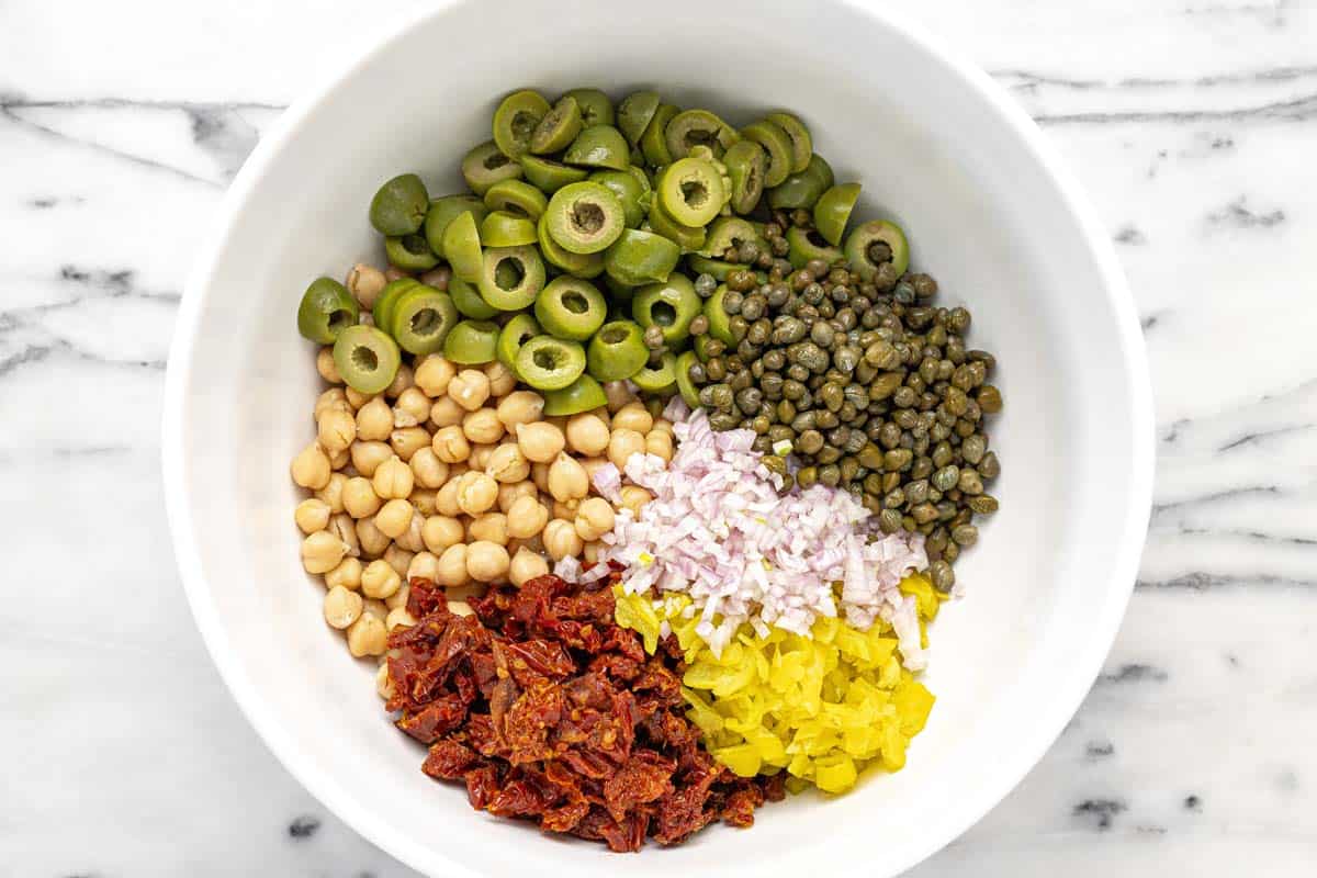 Bowl of ingredients to make marinated chickpea salad.