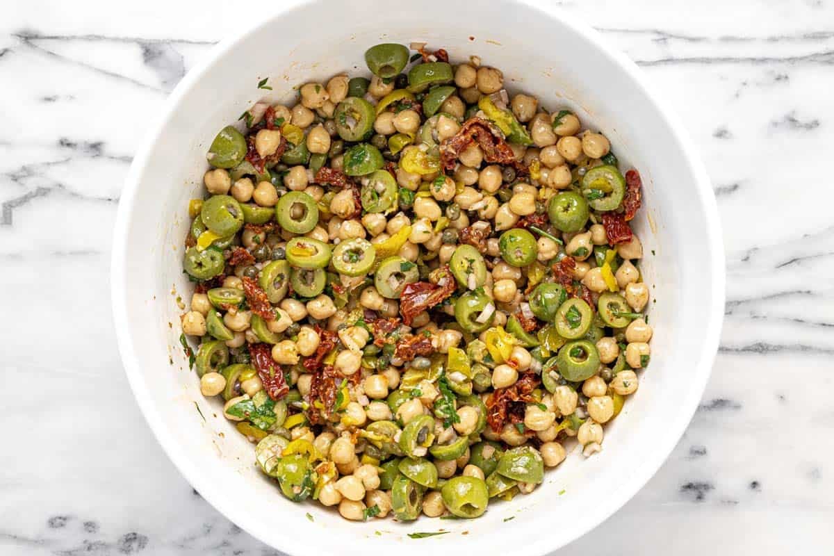 Large bowl filled with marinated chickpea salad.