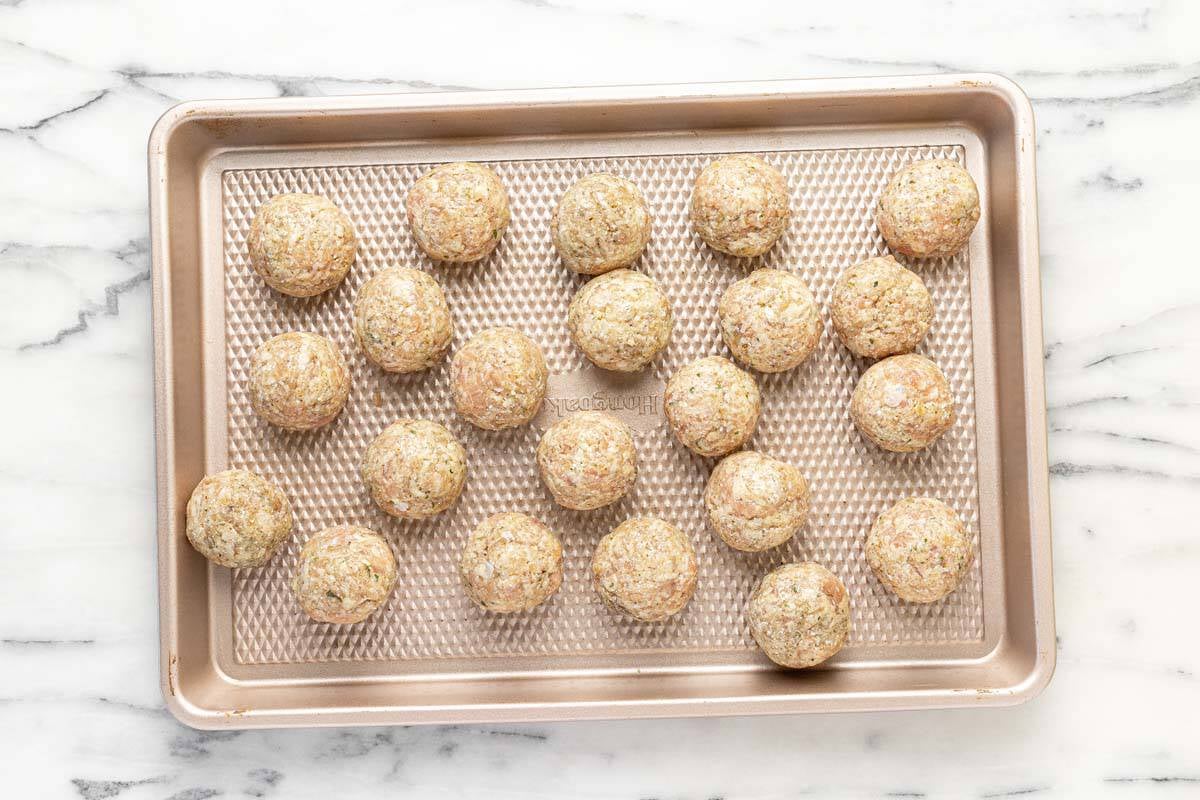 Sheet pan with rolled chicken meatballs.
