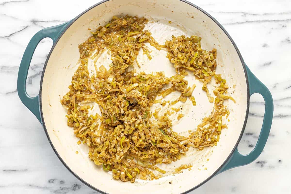 Sauteed leeks and garlic in a large pan.