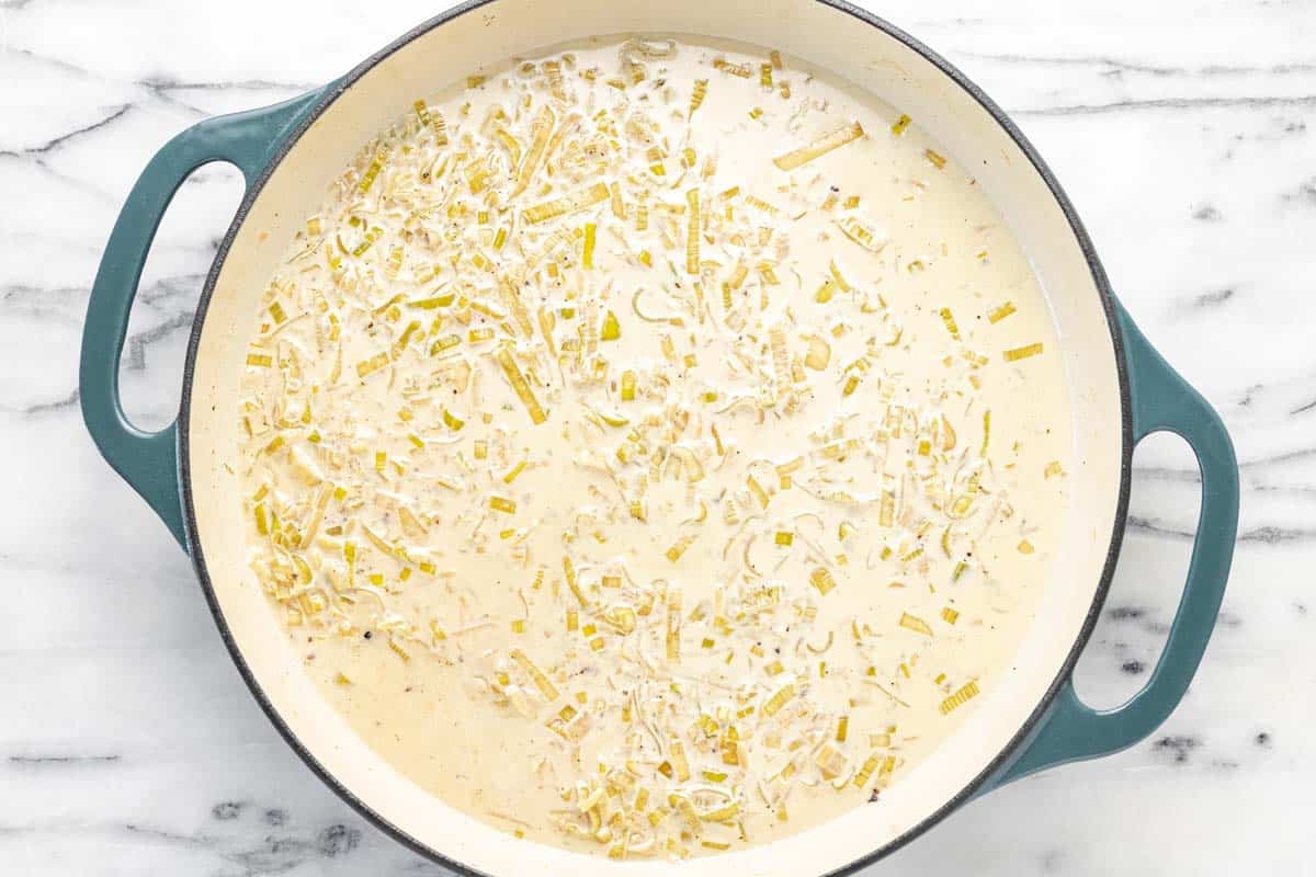 Creamy one pot orzo pasta in a large pan.