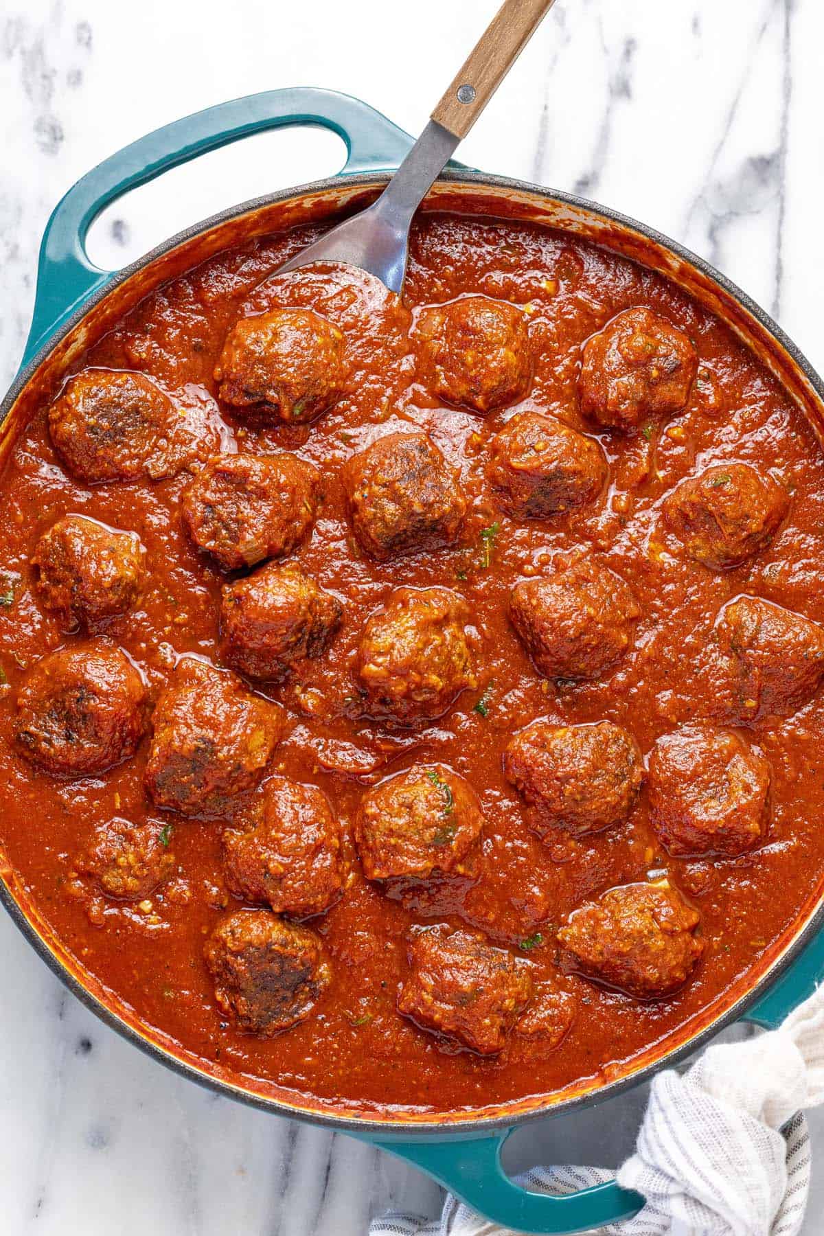 Large pan of meatballs in marinara sauce.