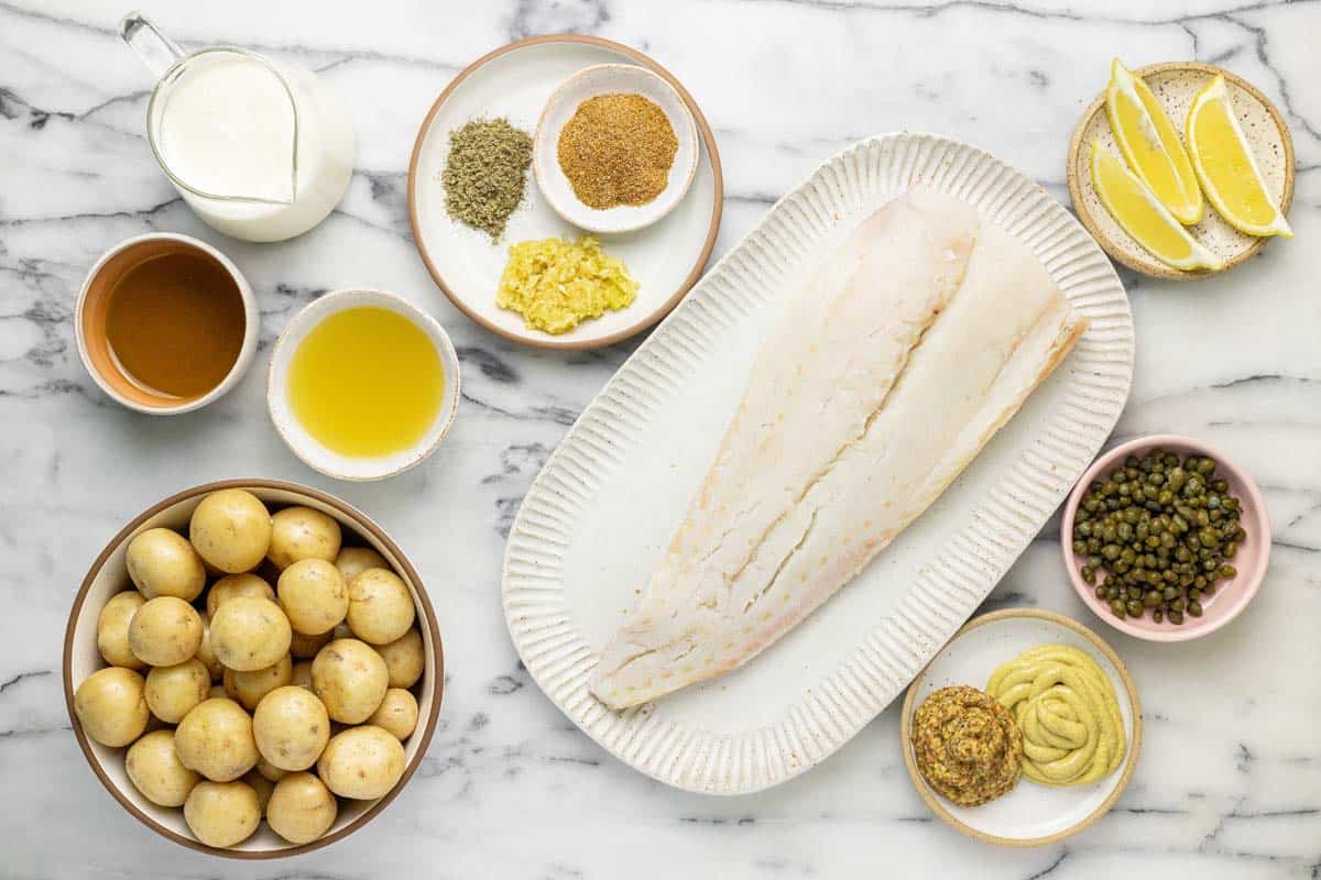 Bowls of ingredients to make baked fish and potatoes. 