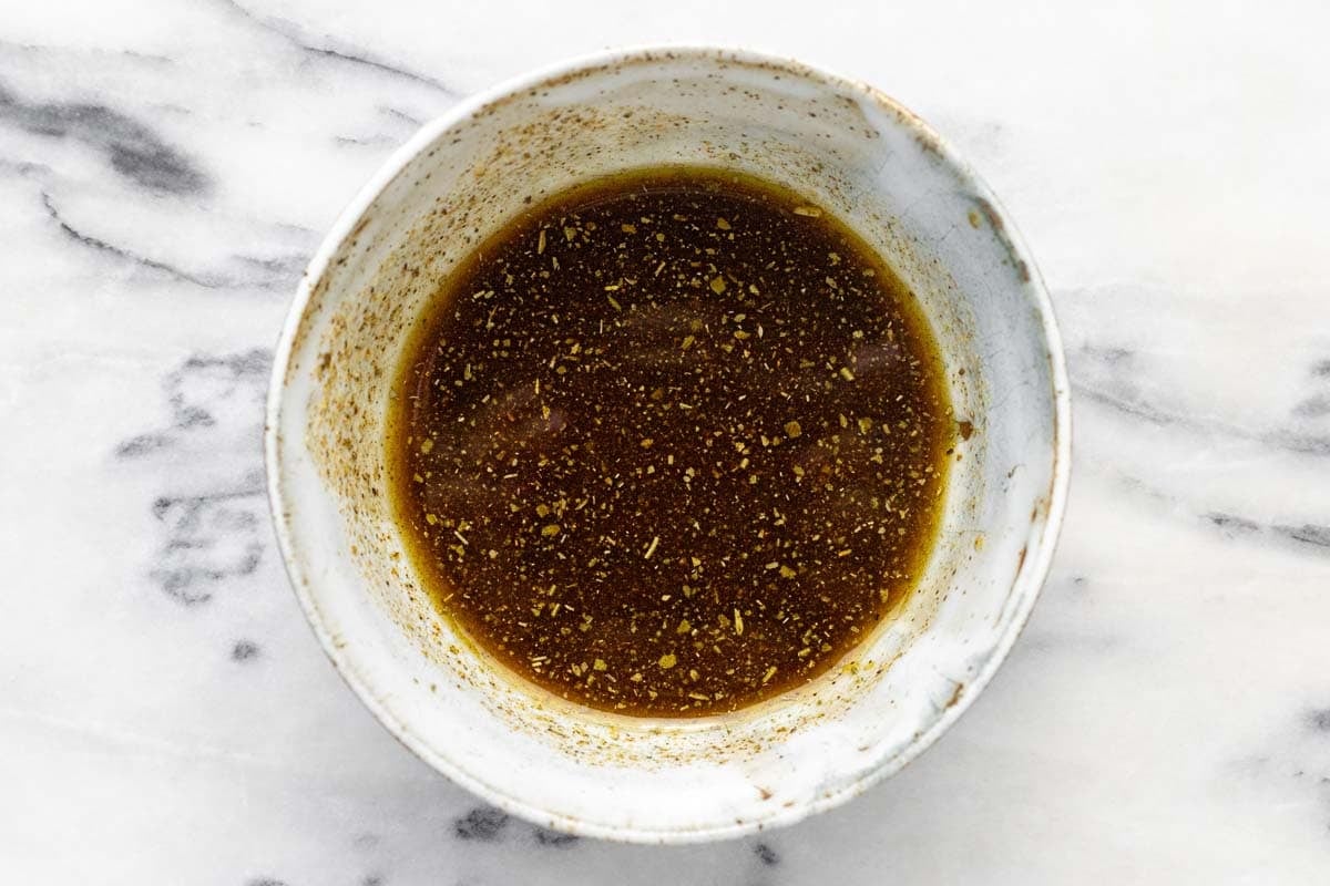 Bowl of olive oil, herbs, and spices. 