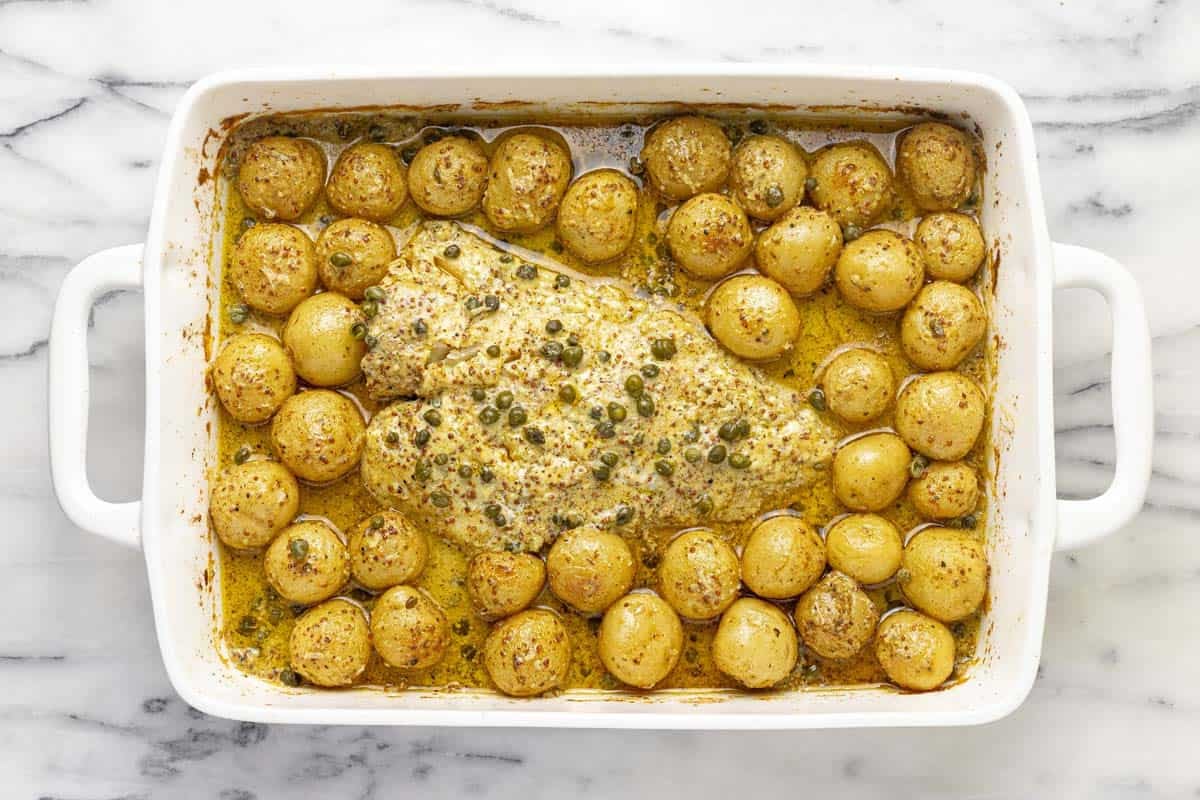 Baking dish filled with roasted potatoes and fish. 