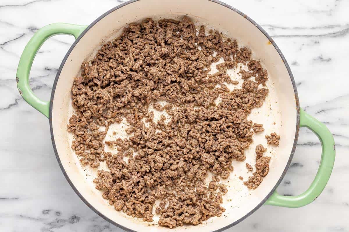 Large pan filled with cooked ground beef.