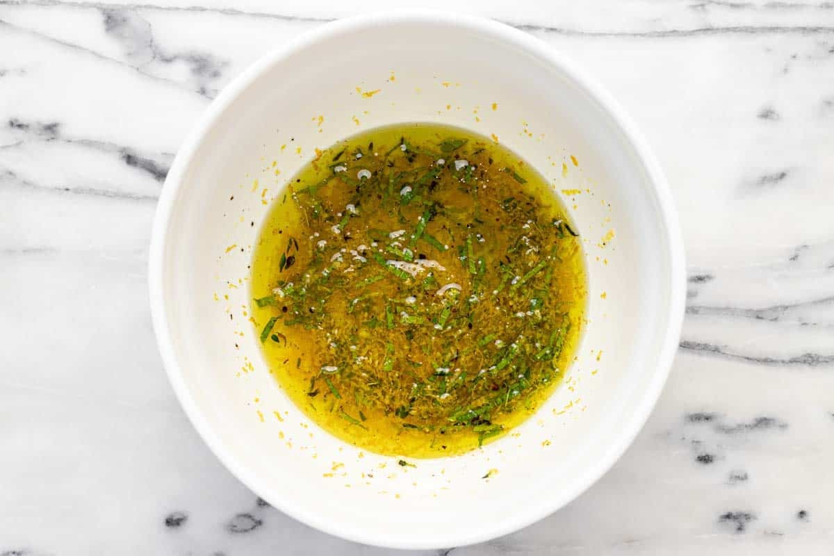 Marinade made with olive oil, orange zest, mint, and thyme.