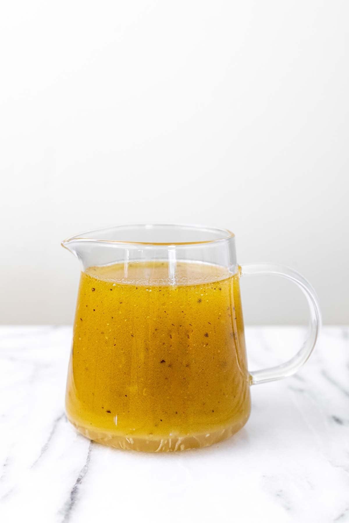 Small pitcher of homemade sesame dressing.