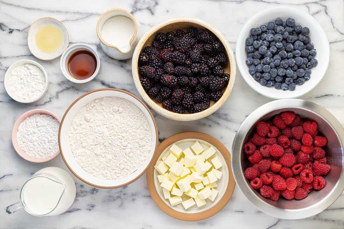 Bowls of ingredients to make this berry cobbler recipe.