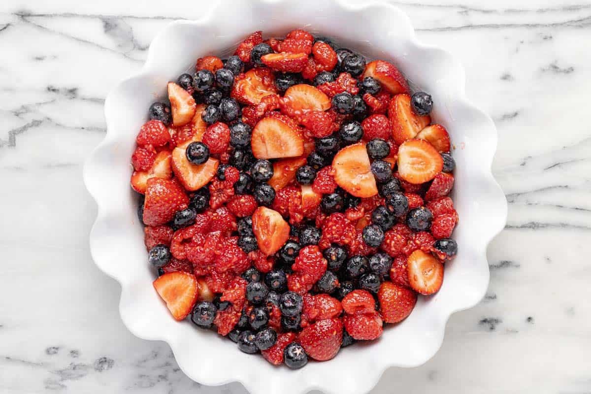Deep dish pie pan filled with mixed berries.