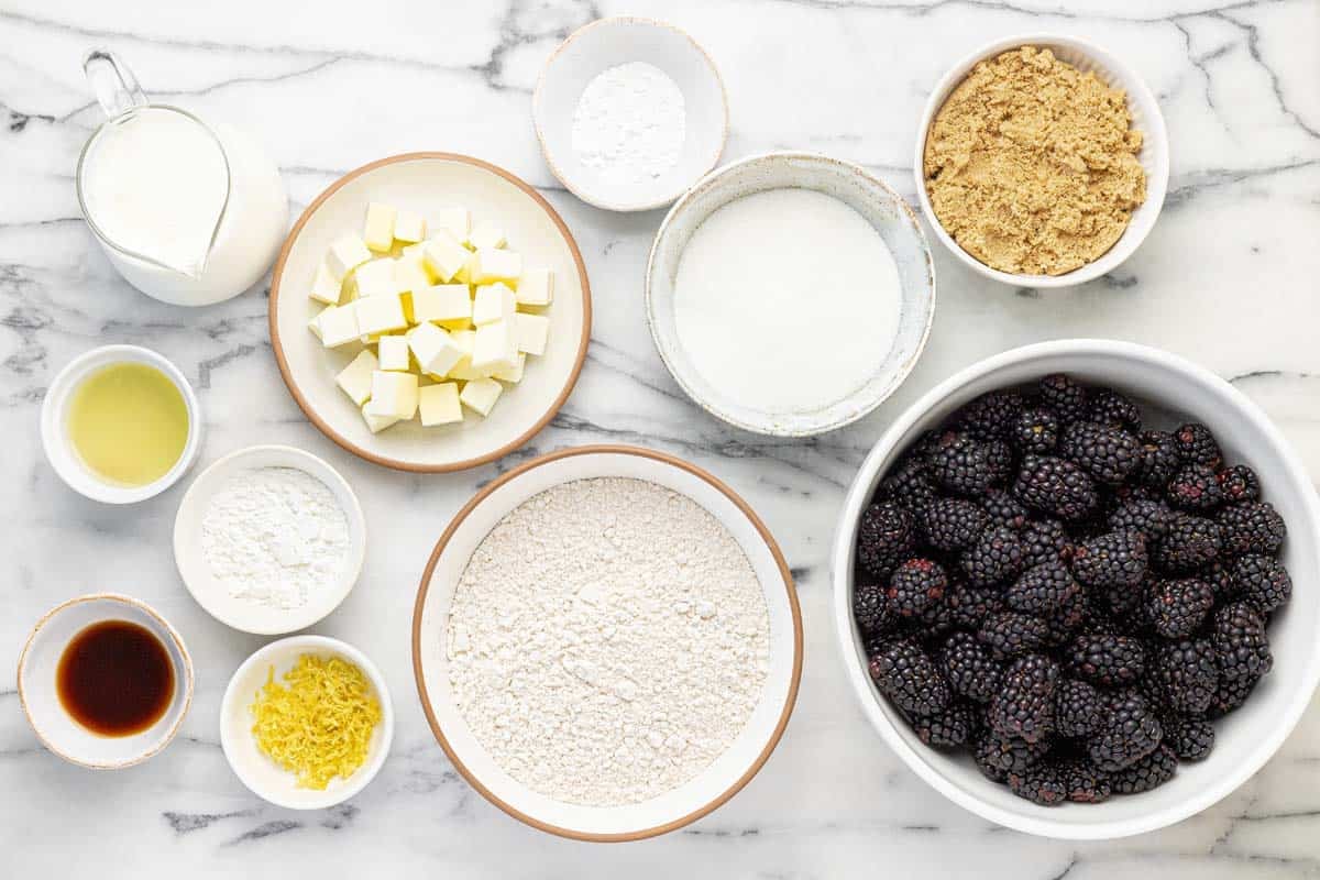 Bowls of ingredients to make blackberry cobbler.