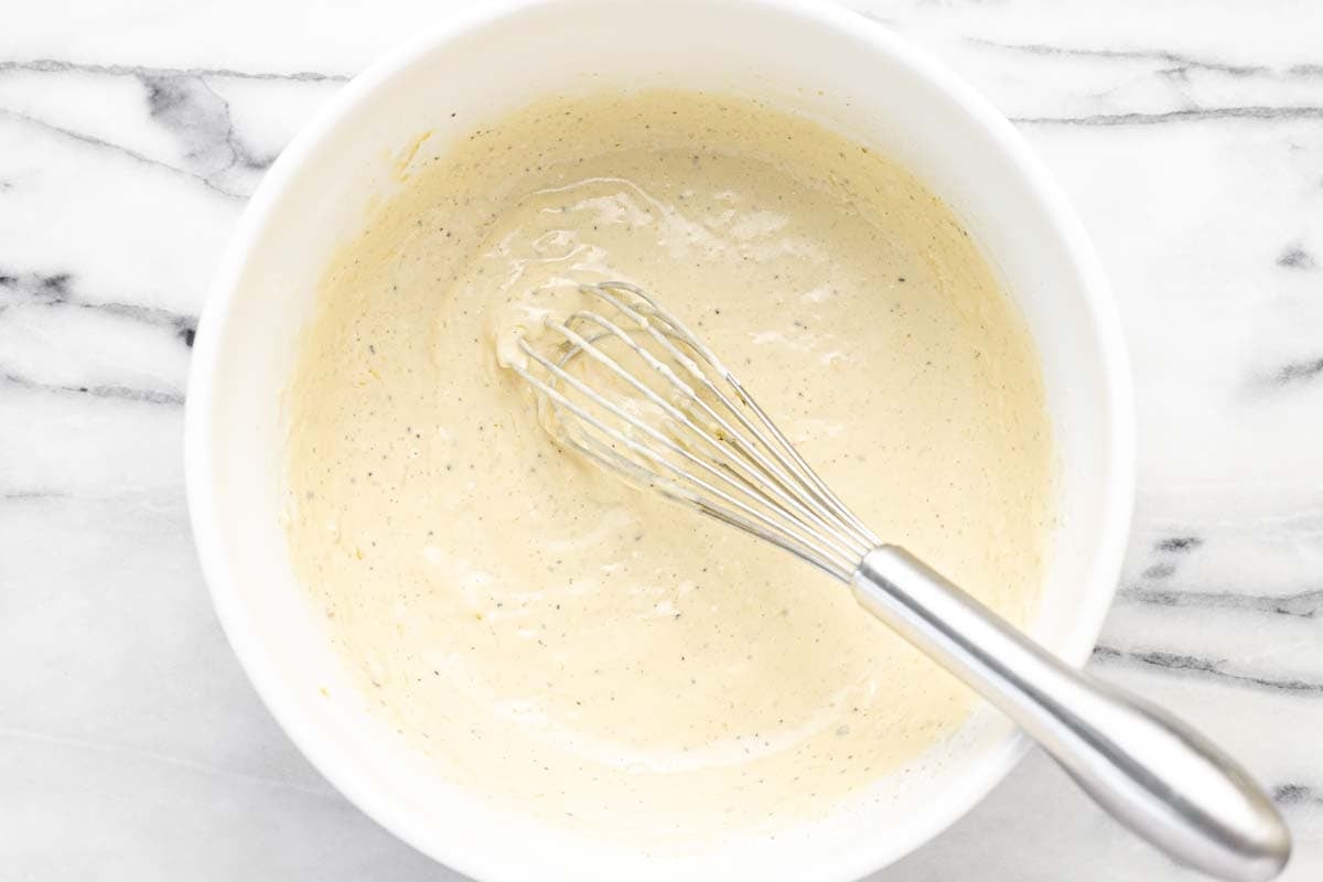 Large bowl filled with homemade Caesar dressing.