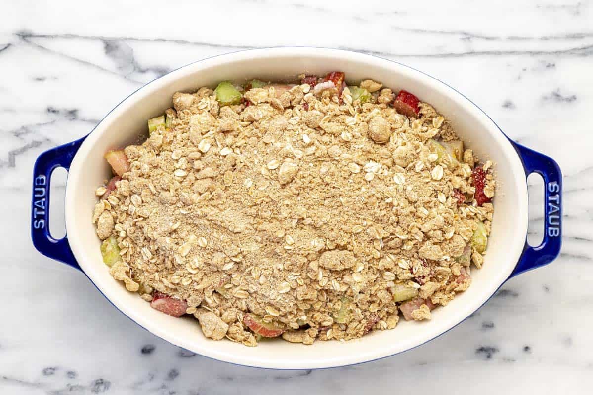 Homemade rhubarb crisp in a large baking dish, ready for the oven.