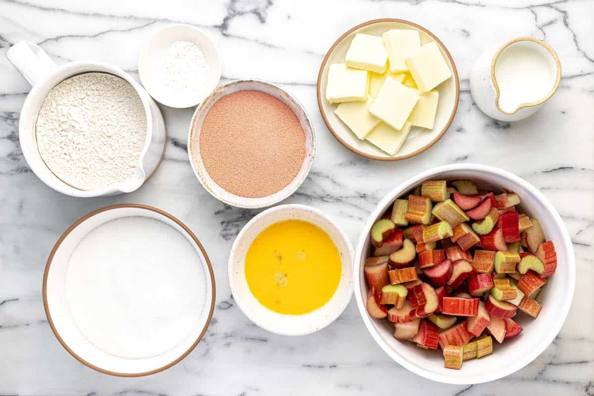Bowls of ingredients to make homemade rhubarb jello dessert.