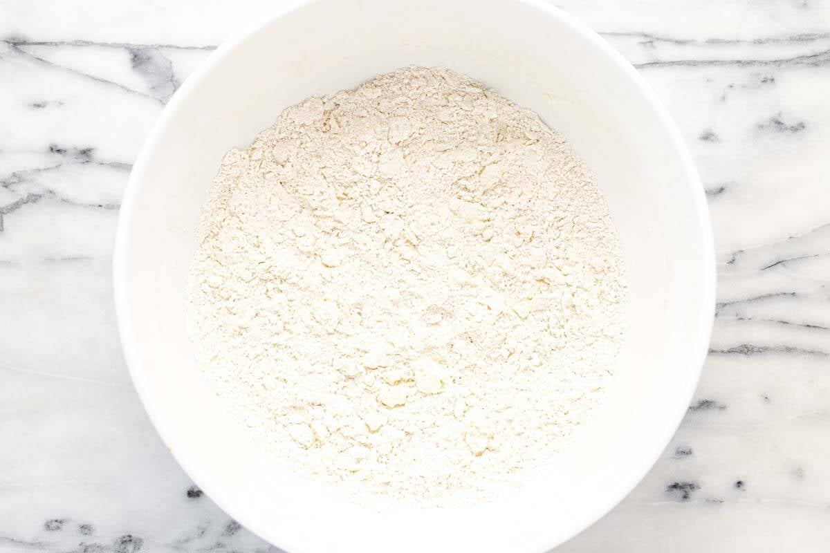 Bowl of dry ingredients with butter cut in for the crust.