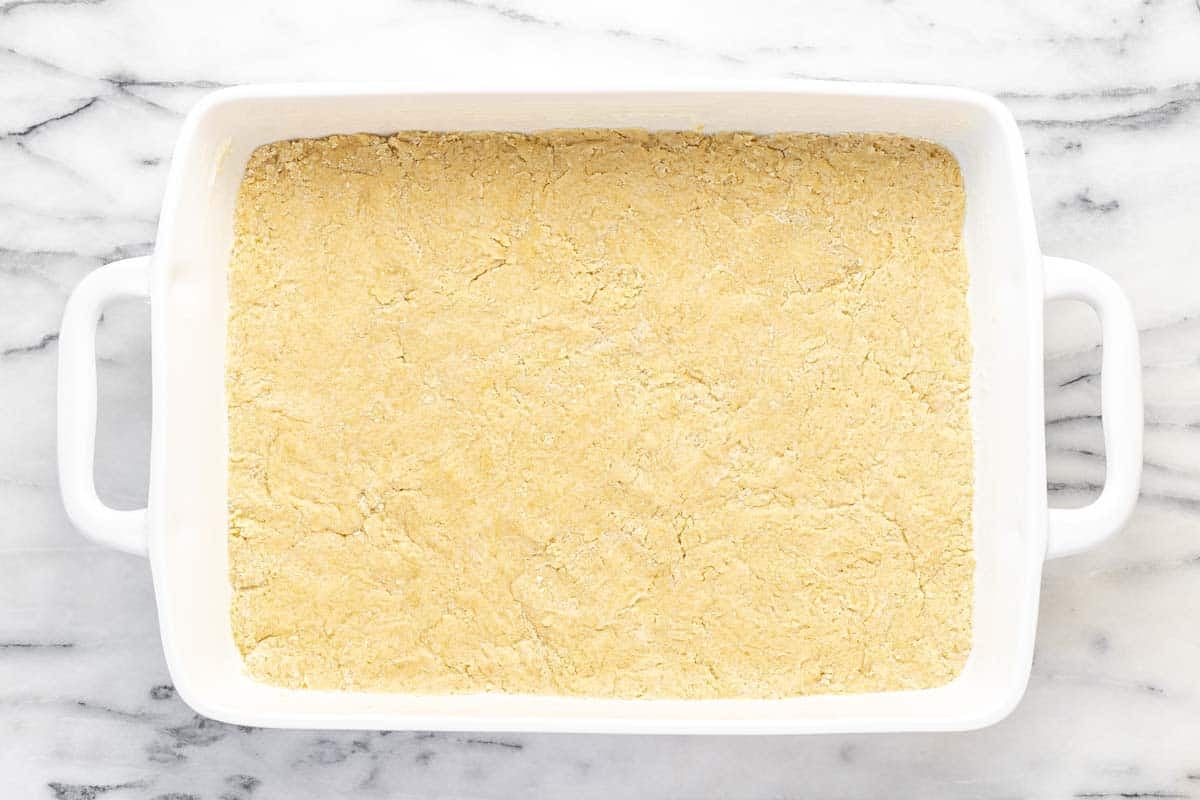 Dough pressed in the bottom of a 9x13 baking dish.