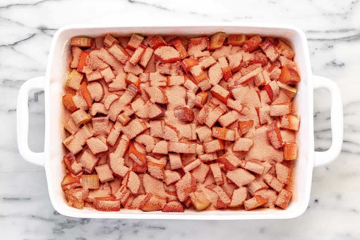 Sliced rhubarb sprinkled with jello powder on top of the crust.