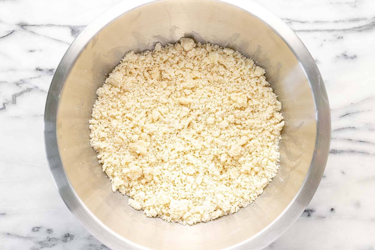 A large bowl filled with crumble topping for the rhubarb dessert.