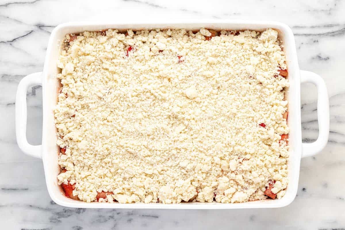 A 9x13 baking dish filled with homemade rhubarb jello dessert.