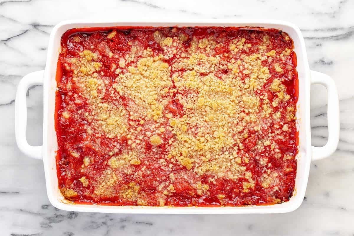 Freshly baked rhubarb jello dessert in a 9x13 baking dish.