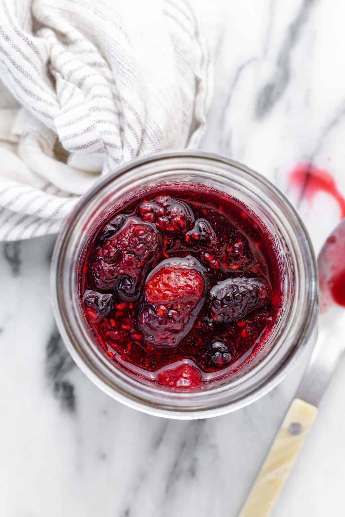 Large mason jar with fresh made berry compote.