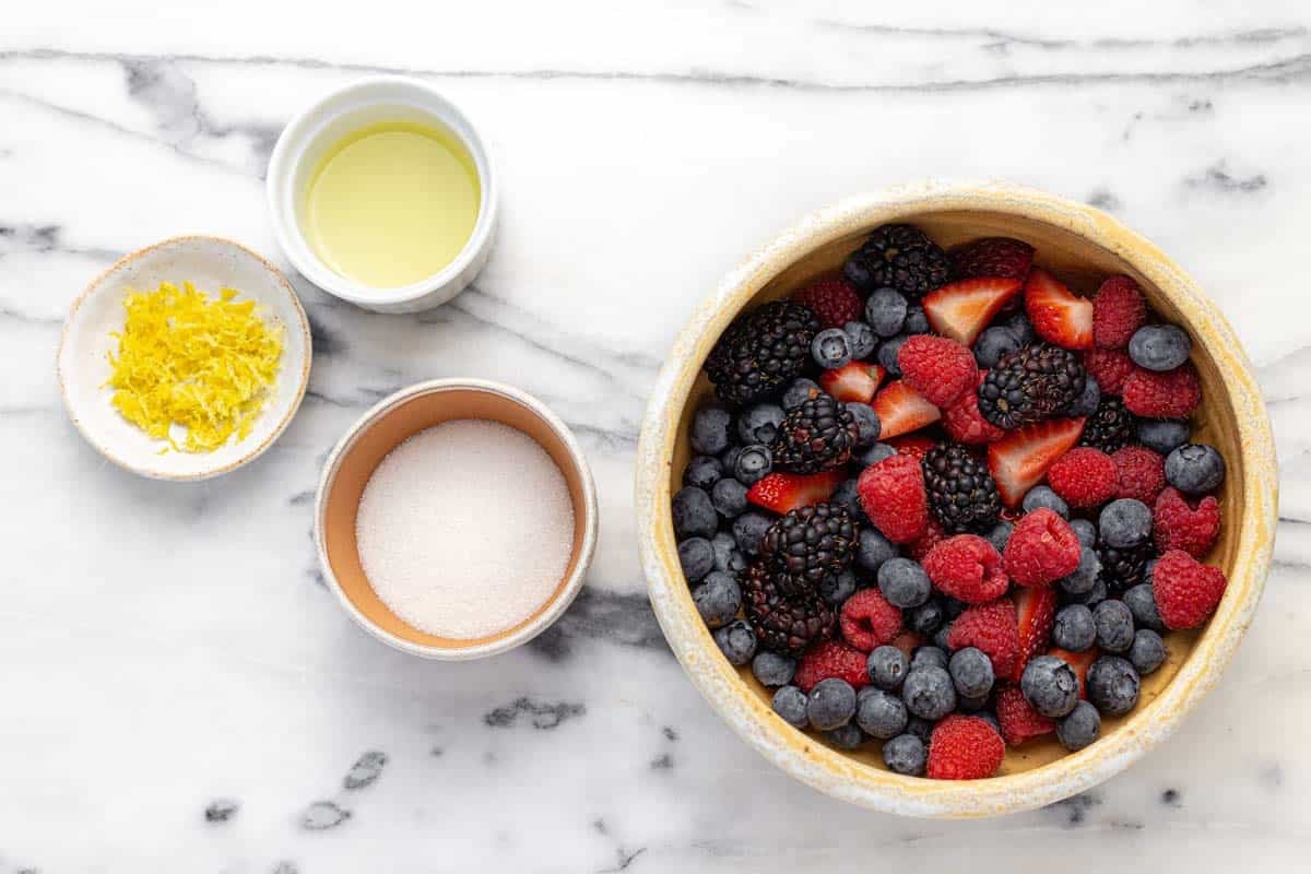 Bowls of ingredients to make berry compote.