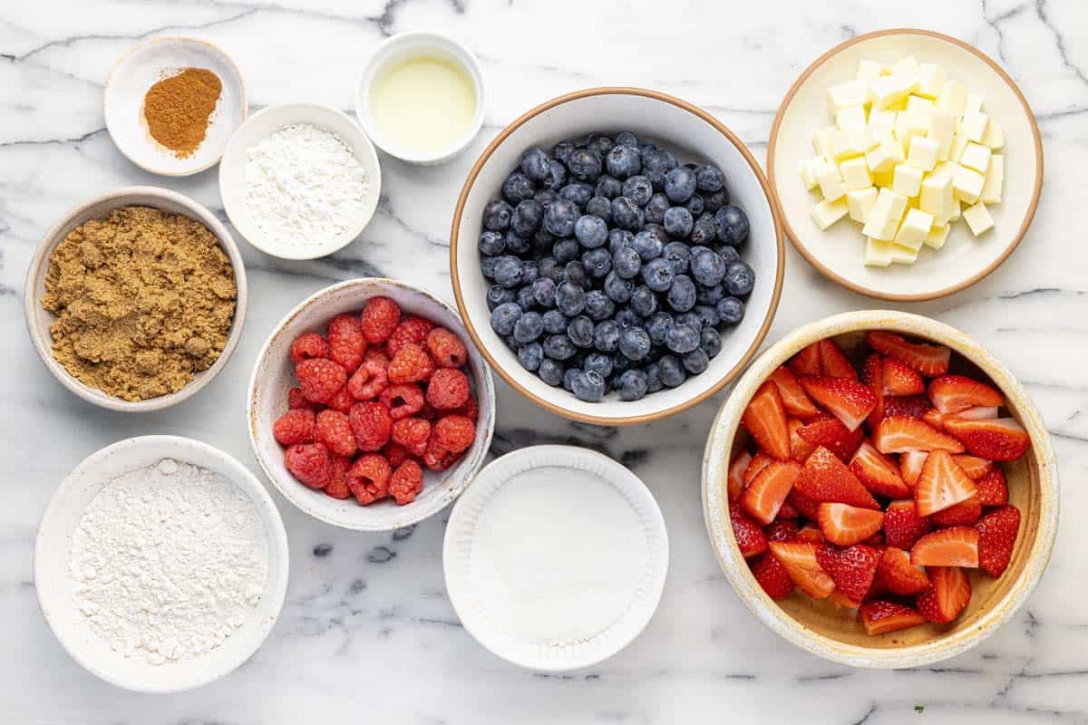 Bowls of ingredients to make berry crumble.
