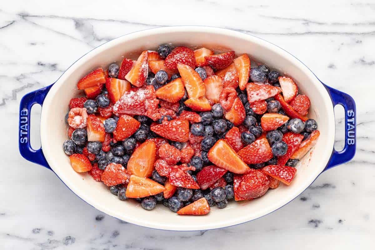 Baking dish filled with fruit tossed in sugar, cornstarch, lemon juice, and salt.