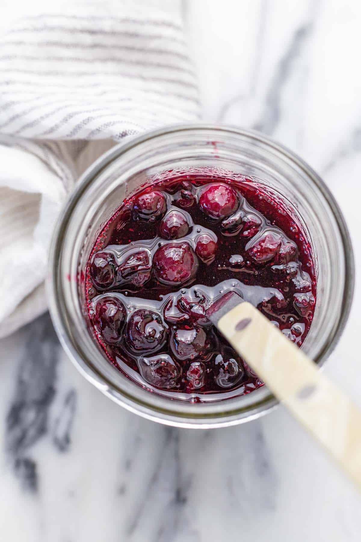 Mason jar filled with homemade blueberry compote.