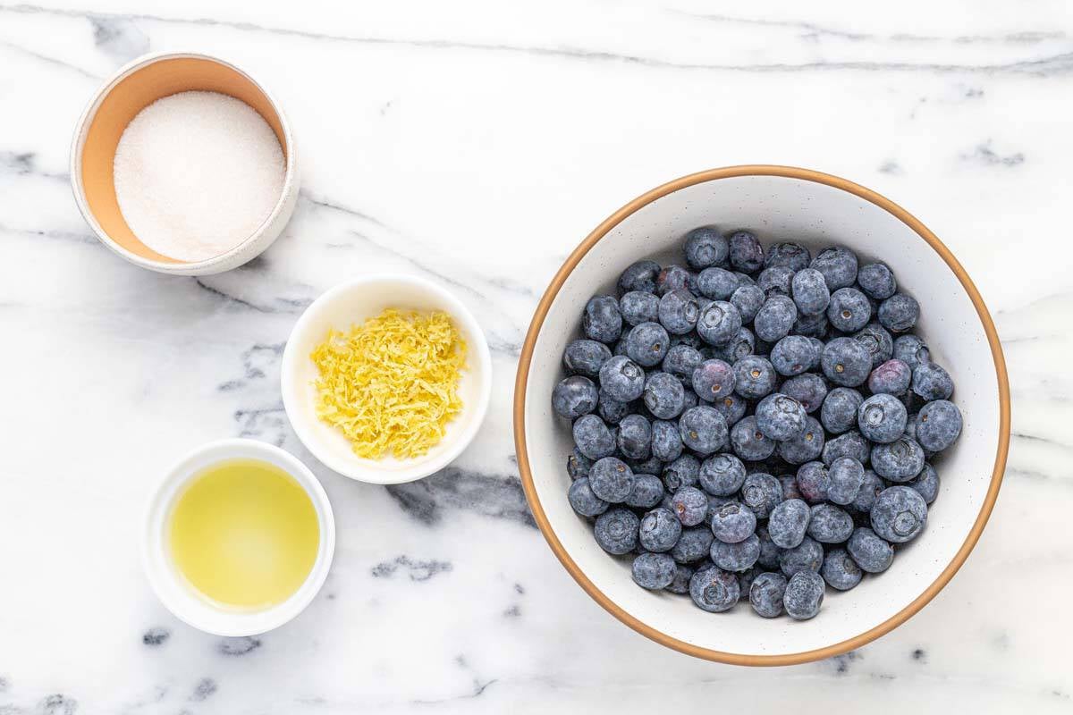 Bowls of ingredients to make blueberry compote.