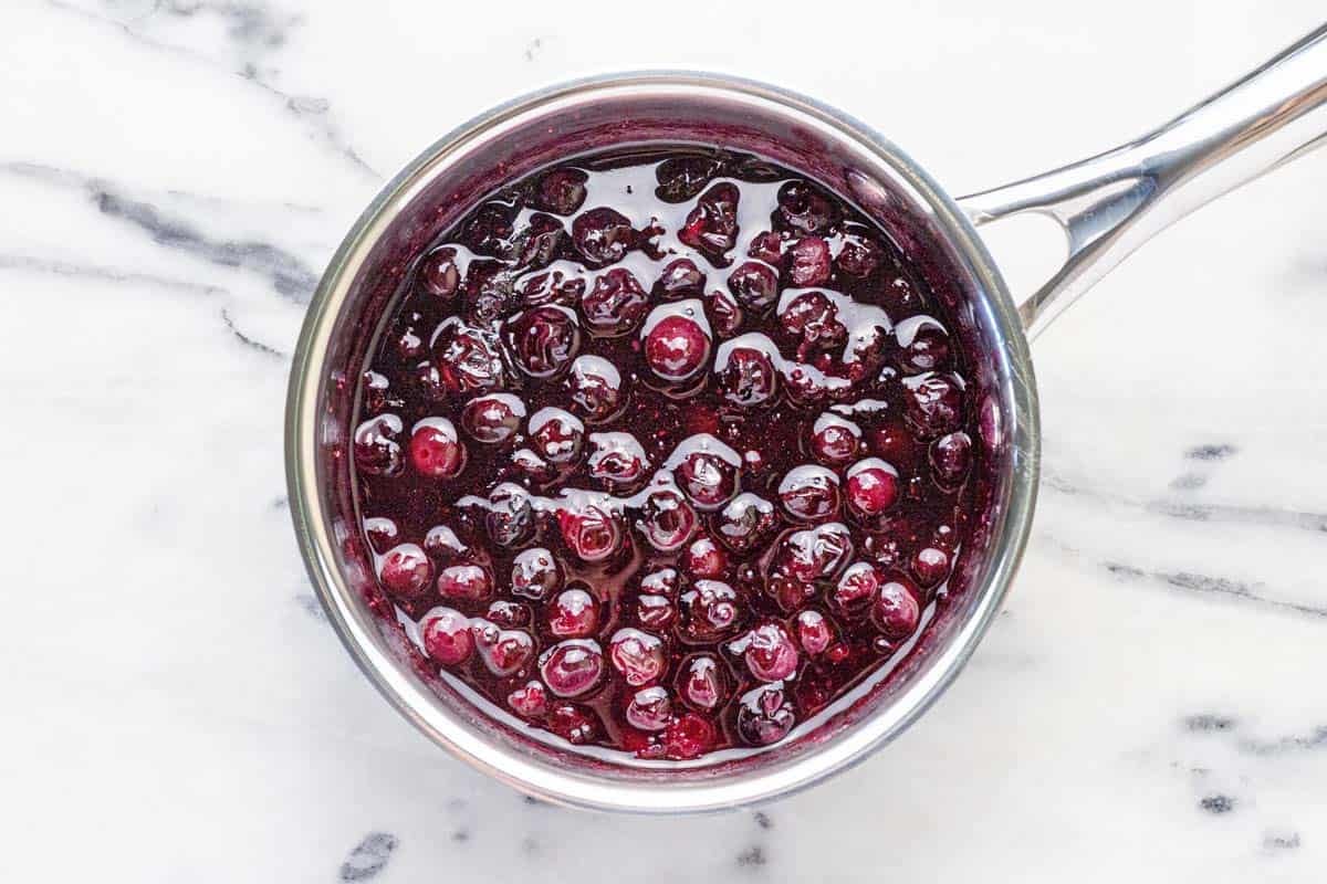 Small saucepan filled with homemade blueberry compote.