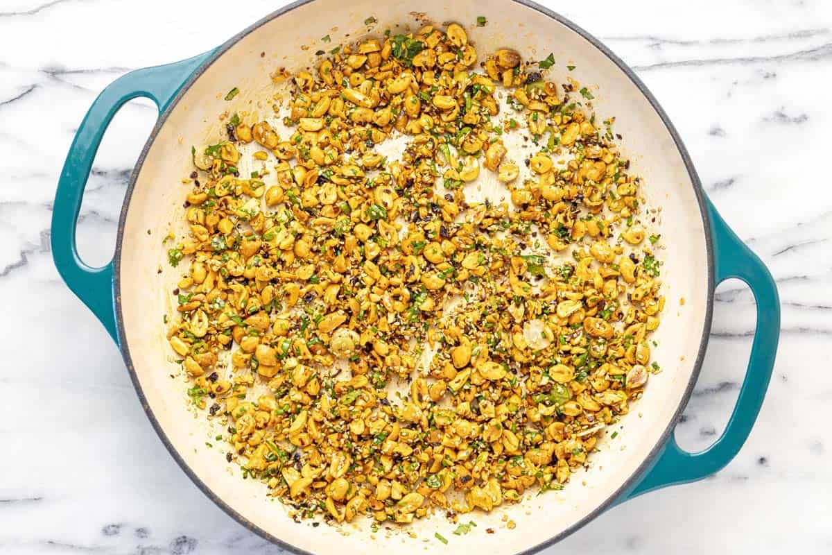 Chopped peanut topping in a large sauté pan.