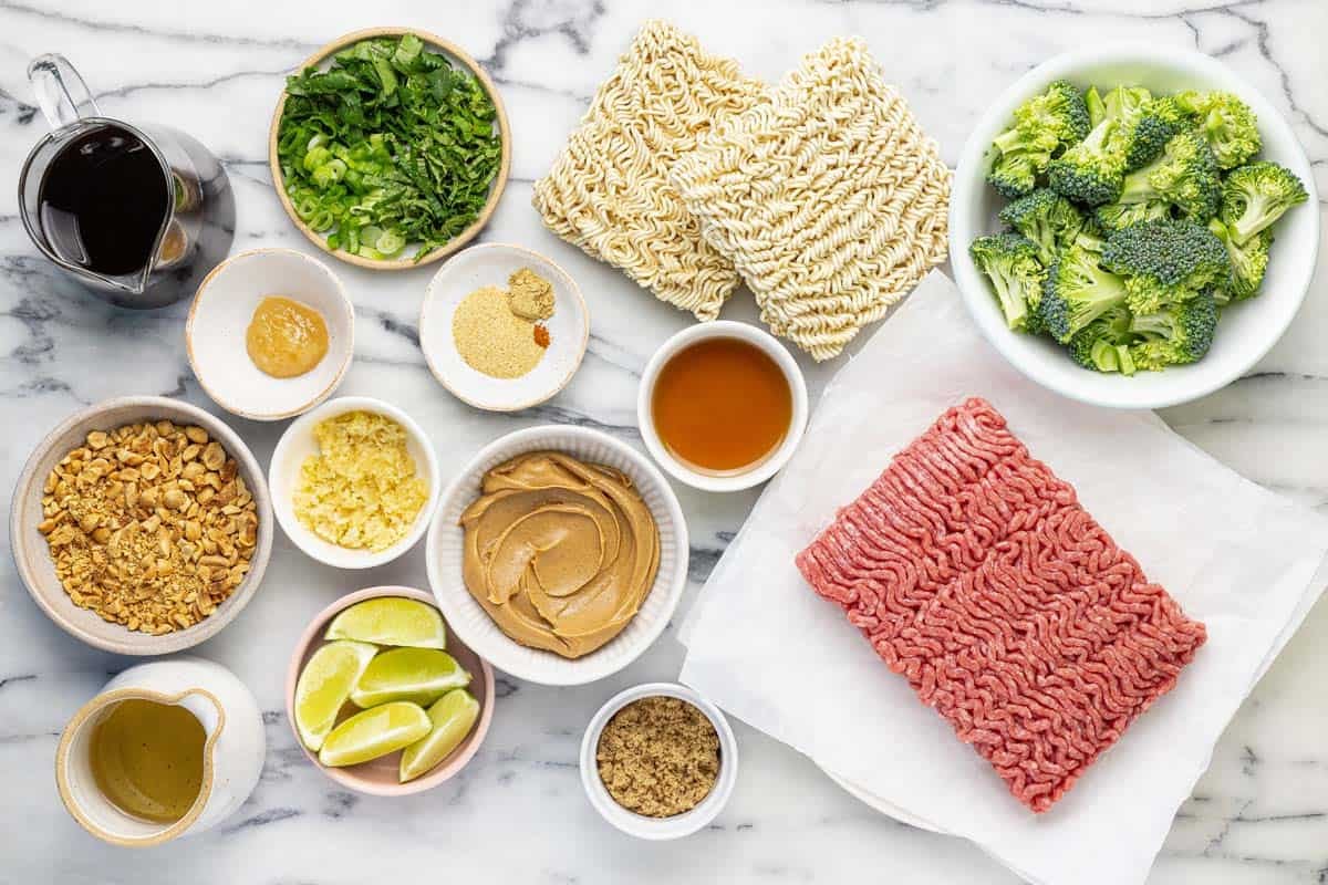 Bowls of ingredients to make sesame ground beef peanut noodles.