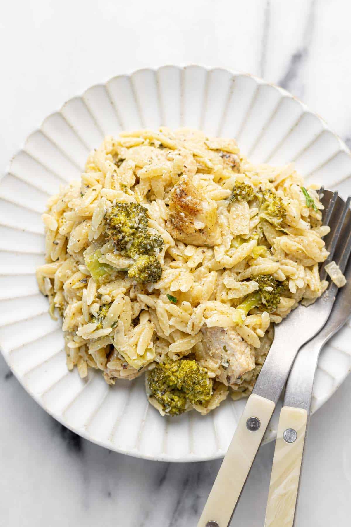 Small plate filled with a serving of Boursin baked chicken and orzo.