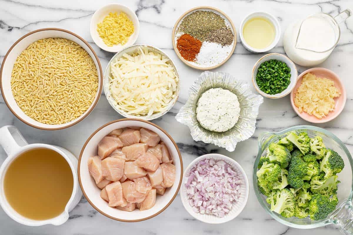 Bowls of ingredients to make baked chicken and orzo casserole.