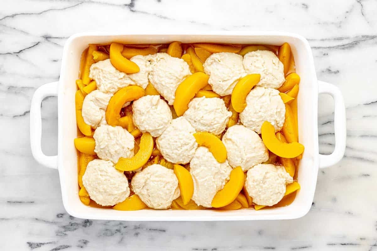 Canned peaches topped with cobbler batter.