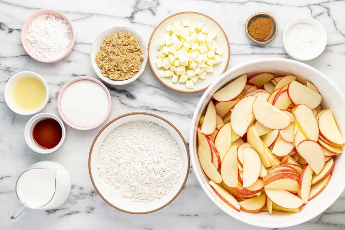 Bowls of ingredients to make apple cobbler. 