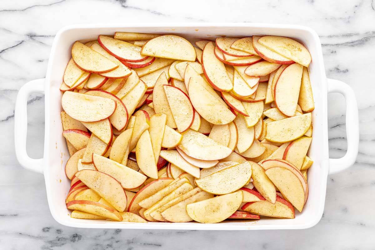 Large pan filled with cinnamon spiced apple slices. 
