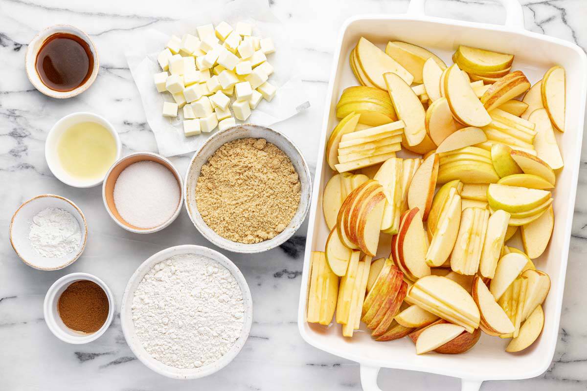 Bowls of ingredients to make apple crumble.